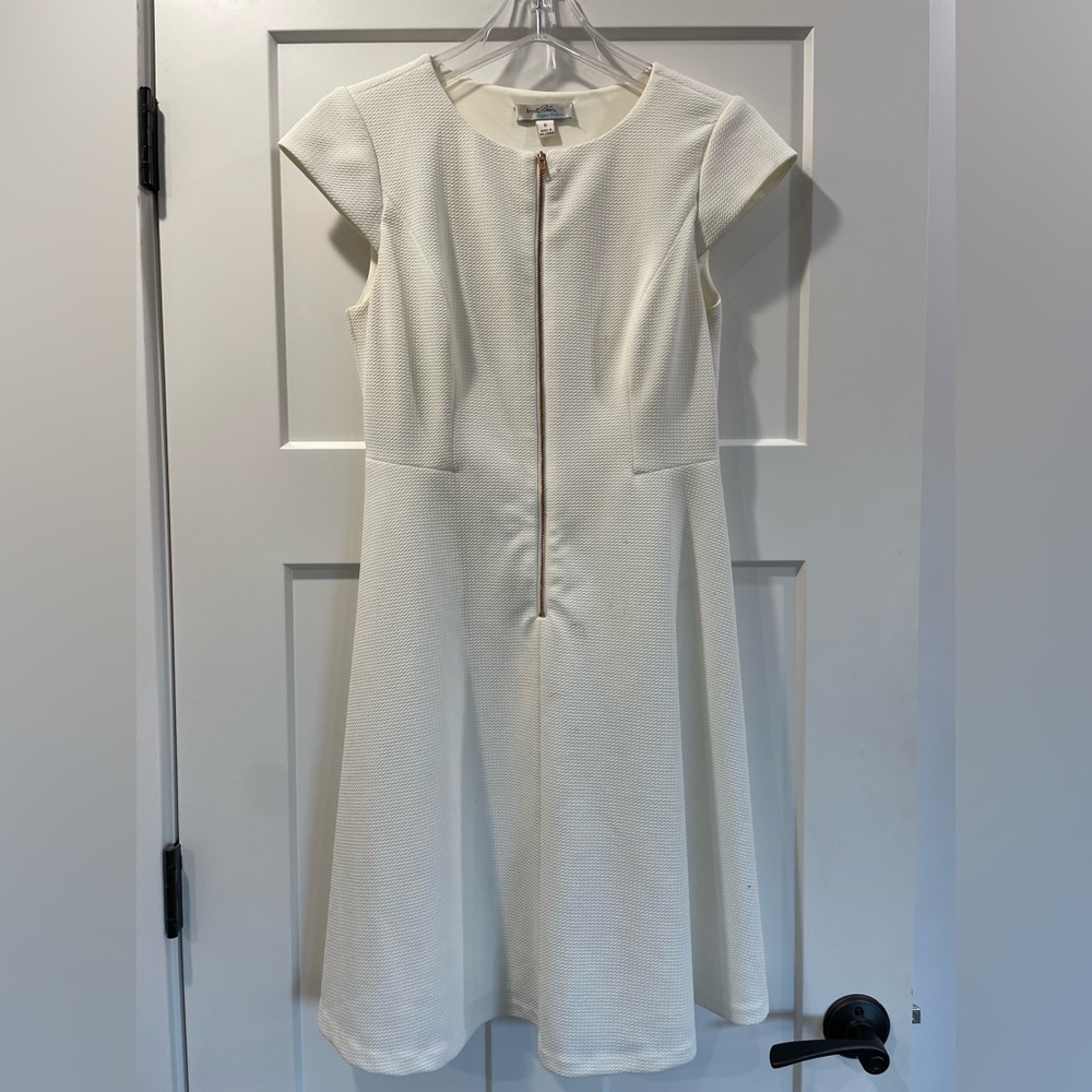 White knee length dress with gold zipper front